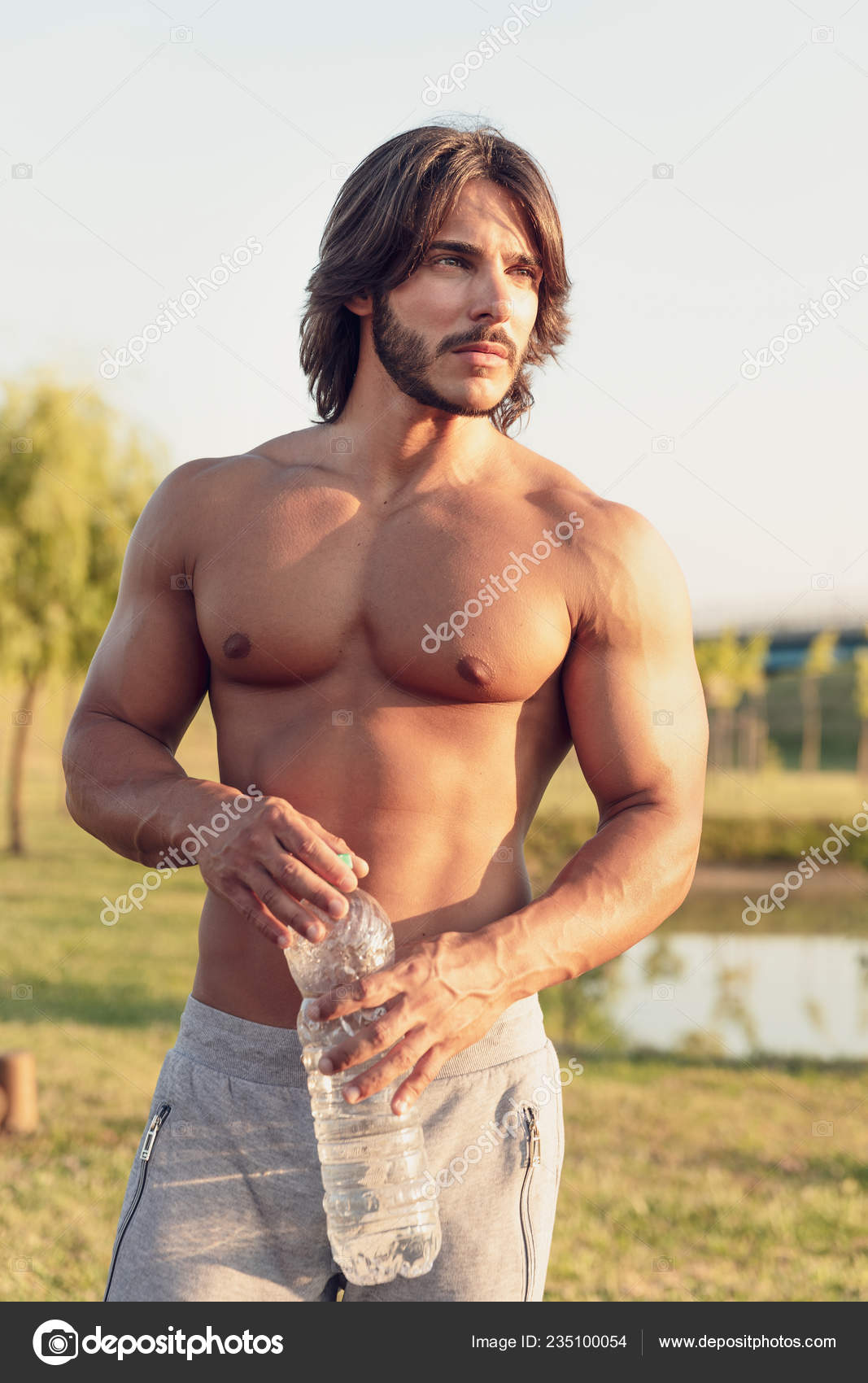 Young athletic man using big bottle of water for home workout 16290443  Stock Photo at Vecteezy