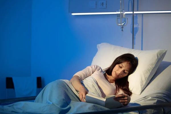 Молода Жінка Лежить Лікарняному Ліжку Вночі Читає Книгу — стокове фото