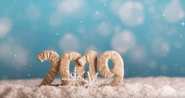 The inscription 2019 new year in the snow on a beautiful blue background