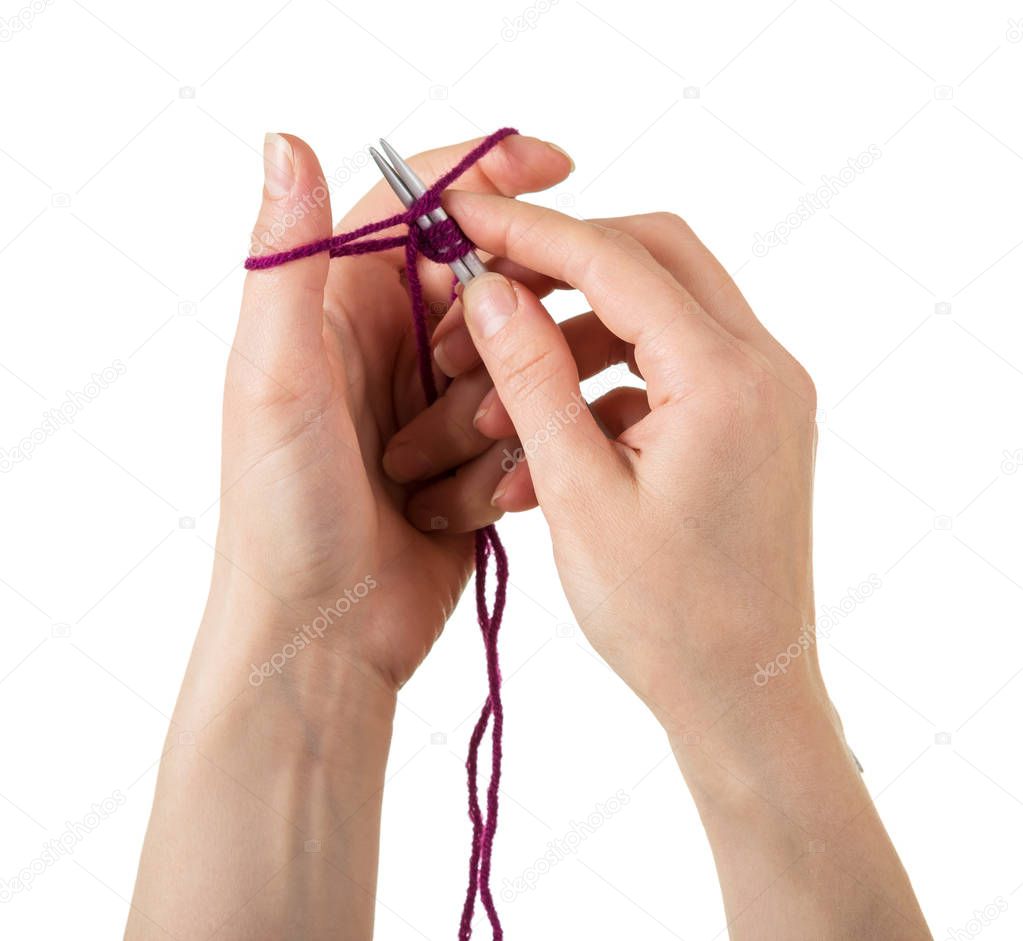 The recruitment process loops for knitting. Female hands knitting with spokes of woolen thread isolated on white background