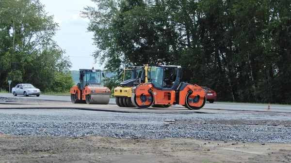 Construction of a road in the Novosibirsk region, Russia. Road machinery.