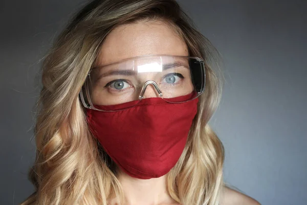 Stylish woman wearing cloth cotton face mask protect against coronavirus covid 19.  Reusable fashionable face mask.