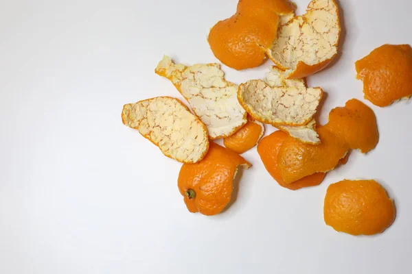 Mandarins orange skin top view. Clementine\'s peel on white background. Abstract concept. Mandarin skin.