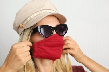 Koronavirüsten korunmak için pamuk bez maskeli genç bir kadın. El yapımı pamuk maske.. 