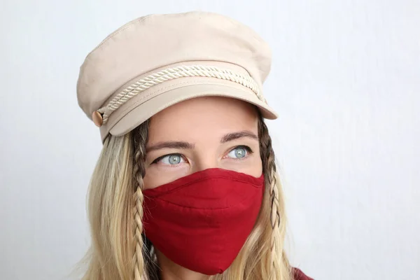 Young woman wearing cotton cloth face mask to protect against coronavirus. Stylish handmade cotton face mask.