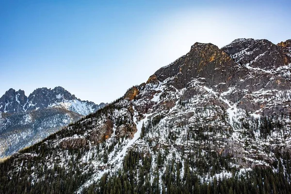 Prachtig shot van hoge rotsachtige bergen en heuvels bedekt met sneeuw restjes in het voorjaar — Stockfoto