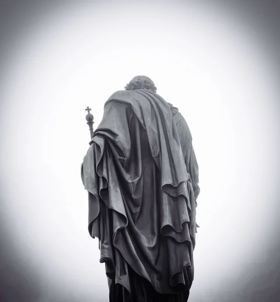 Estatua de un hombre con una túnica y bastón por detrás en blanco y negro —  Fotos de Stock
