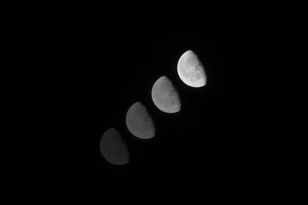 Fases lunares em um fundo escuro escuro-escuro — Fotografia de Stock