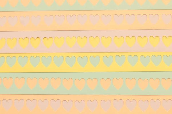 Colorful background with cutout hearts — ストック写真
