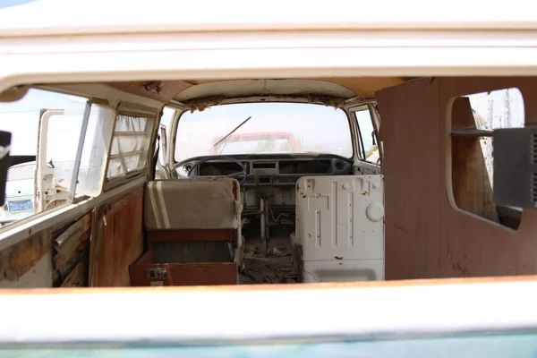 Inside of an old rusty broken beach vagon with worn out cabin seats — Stock Photo, Image