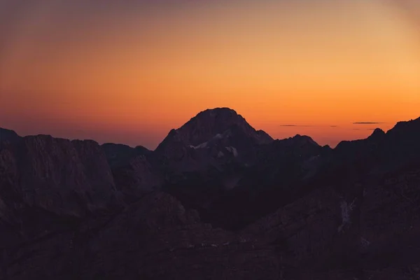 A beautiful aerial shot of high mountains during sunset