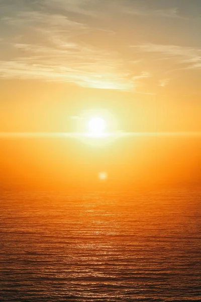 Vertical shot of a beautiful sea at sunset at Big Sur, California, USA