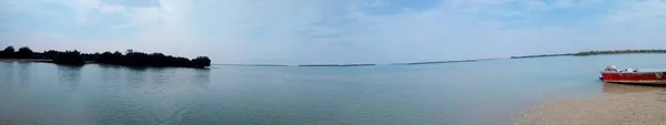 Panoramic shot of a sea with trees at an island on Qeshm