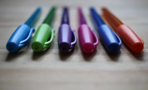 Collection of colored pens laid on a table — Stock Photo, Image