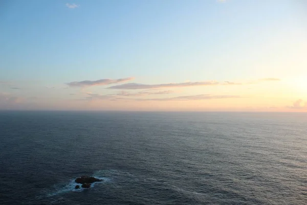 Weitwinkelaufnahme des wunderschönen Ozeans mit herrlich blauem Himmel und Wolken bei Sonnenaufgang — Stockfoto