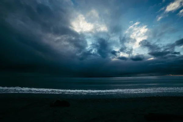 A beautiful dramatic shot of coast of the ocean with breathtaking sky making amazing natural scenery