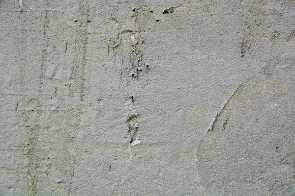 Closeup shot of naturally weathered grungy wall with oil paint leftovers on marble — Stock Photo, Image