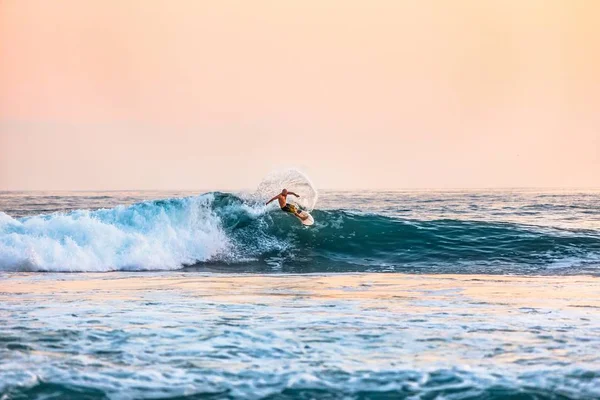 Снимок мужчины, занимающегося серфингом в море днем — стоковое фото