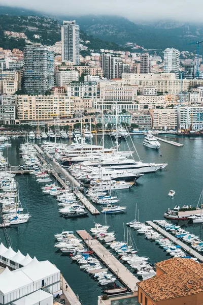 Beautiful aerial shot of a dock with many parked ships and an urban city in the background — Stock Photo, Image