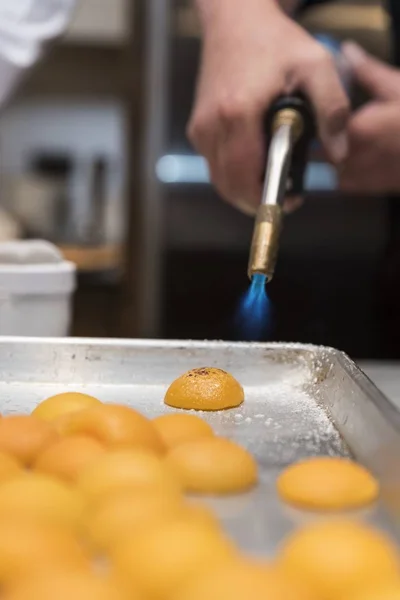 Closeup shot of a chef working with eggs and making something in the kitchen of a cafe