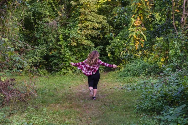 Weibchen läuft in den Wald mit Bäumen im Hintergrund — Stockfoto