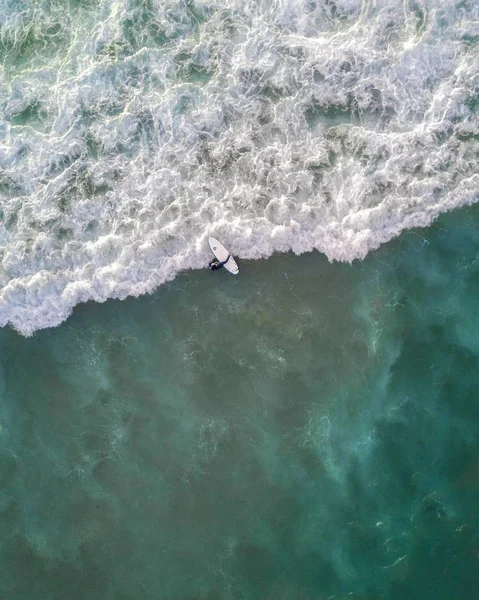 Beautiful aerial shot of ocean waves right from above in bird's eye view - perfect wallpaper