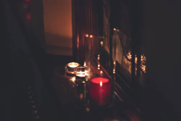 Closeup shot of lighted pillar candles on the table — Stock Photo, Image