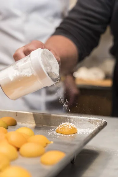 Closeup shot of a chef working with eggs and making something in the kitchen of a cafe