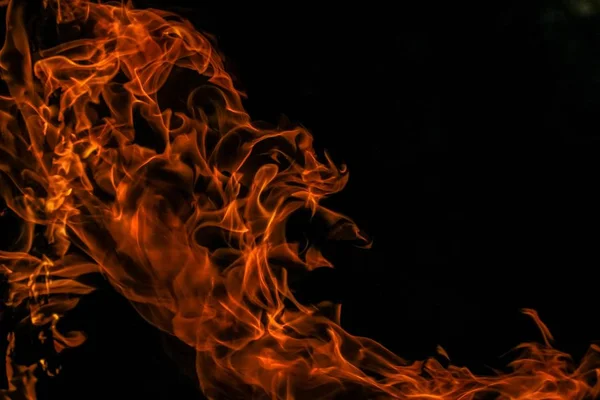 Beautiful shot of a bursting flame with a dark background — Stock Photo, Image