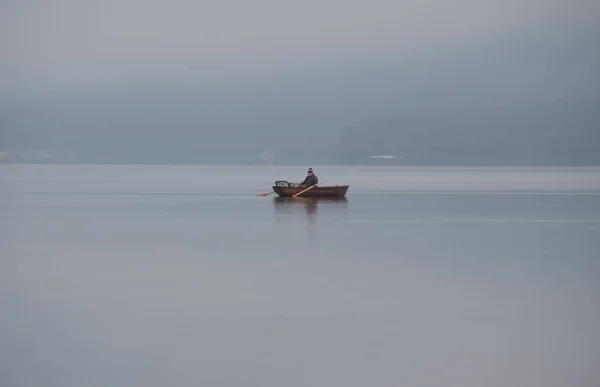 Person on a rowboat alone in the sea