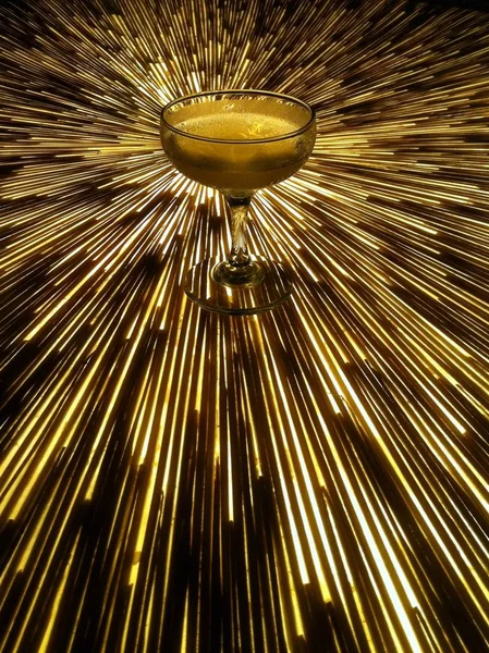 Altında ışık olan bir masada bir kokteylin dikey çekimi — Stok fotoğraf
