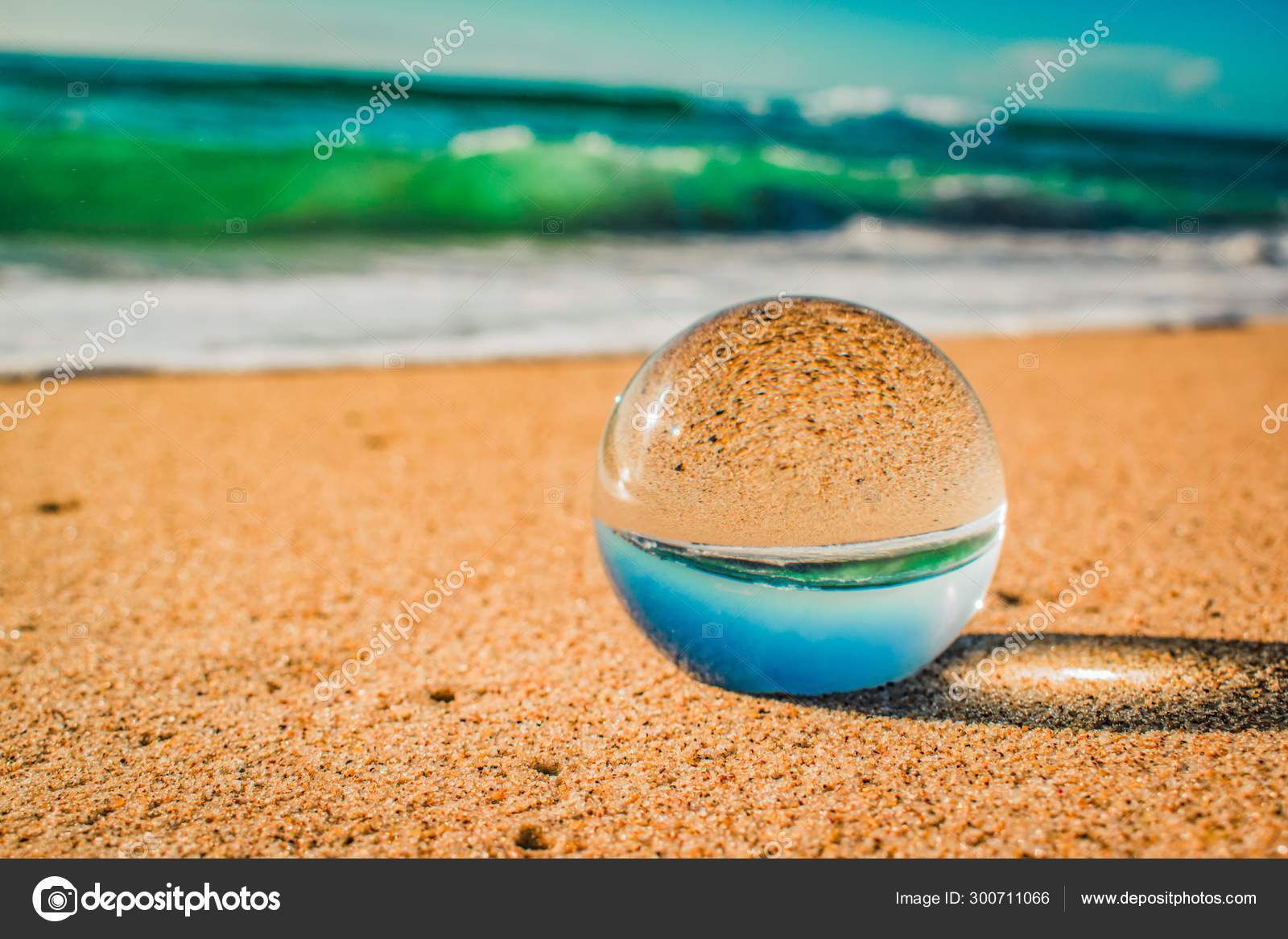 Crystal lens ball creative photography of a sandy beach Stock Photo by  ©Wirestock 300711066