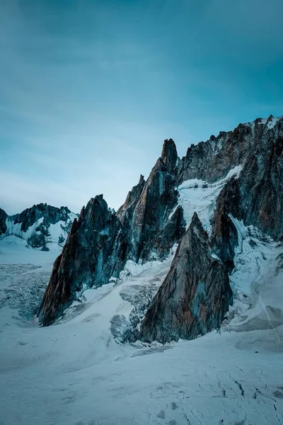 Tiro Vertical Uma Colina Nevada Perto Montanha Sob Céu Azul — Fotografia de Stock