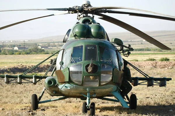 A closeup shot of an armed military fighter helicopter in the military base in the desert