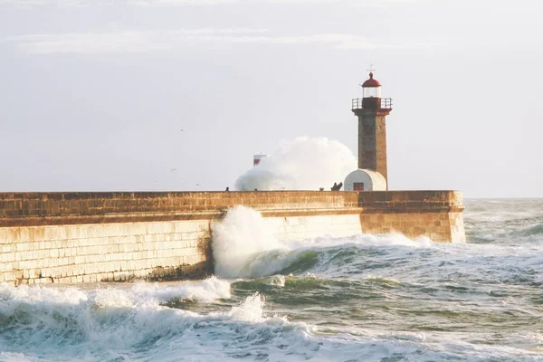 Beautiful Shot Tall Lighthouse Tower Beacon Shore Sea Strong Waves Royalty Free Stock Images