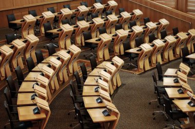 A horizontal shot of the desks inside of the Scottish parliament building clipart