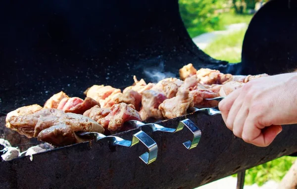 Masculino fazendo churrasco em um churrasco em um belo dia ensolarado — Fotografia de Stock