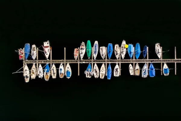 An overhead shot of parked small boats on the coast of the sea