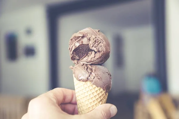 A selective focus shot of tasty chocolate ice cream on a brown cone