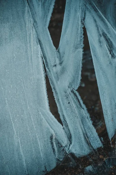 Vertical shot of a piece of an old torn apart jean material — Stock Photo, Image