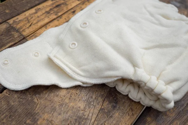 Closeup shot of organic white baby diapers on a wooden surface — Stock Photo, Image