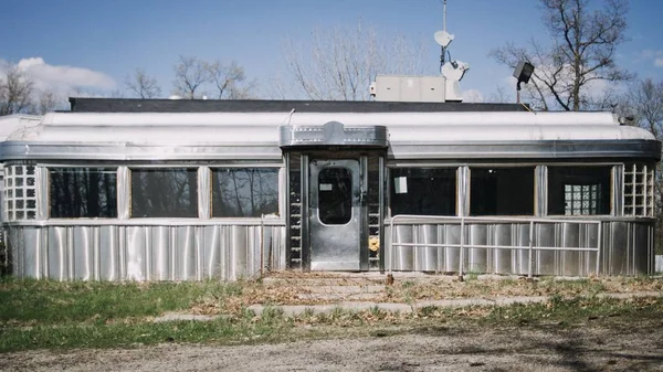 Wide shot of an empty gray diner during daytime