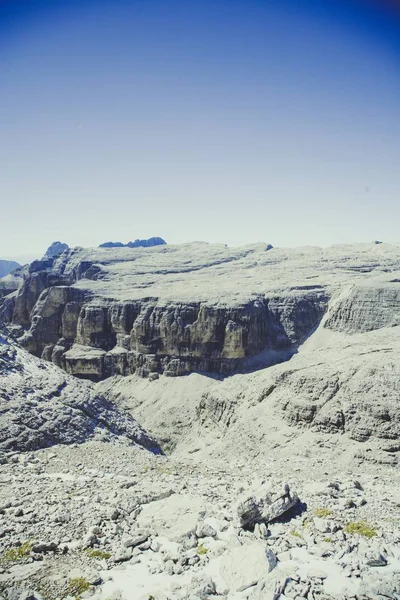 A beautiful shot of rocky mountains under the clear blue sky on a sunny day