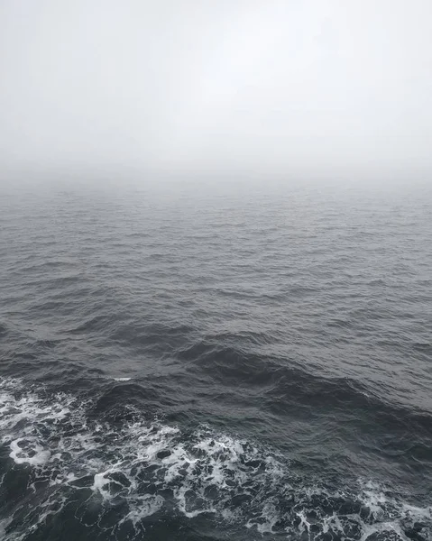 Colpo verticale del sereno mare salmastro nella Columbia Britannica, Canada, ricoperto da una fitta nebbia — Foto Stock