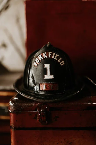 Vertical closeup shot of a firefighter helmet with Yorkfield and the number 1 written on it — Stock Photo, Image