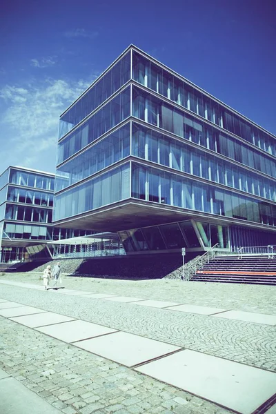 Low angle shot of a building with windows under the beautiful blue sky — ストック写真