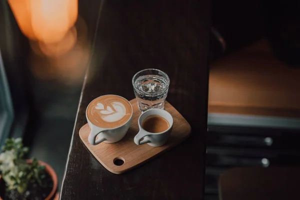 Hochwinkelaufnahme von Kaffee auf einem Holzboden mit verschwommenem Hintergrund — Stockfoto