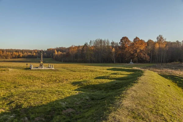 Fotografía horizontal de un monumento de piedra en el campo de Borodino, Rusia durante el otoño rodeado de árboles —  Fotos de Stock