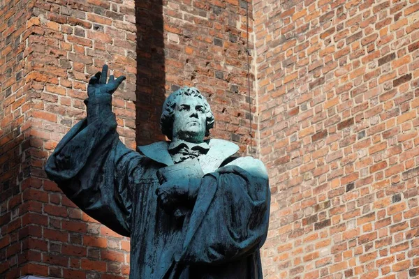 Nära skott av en Martin Luthar staty med tegelväggar i bakgrunden på dagen i Tyskland — Stockfoto