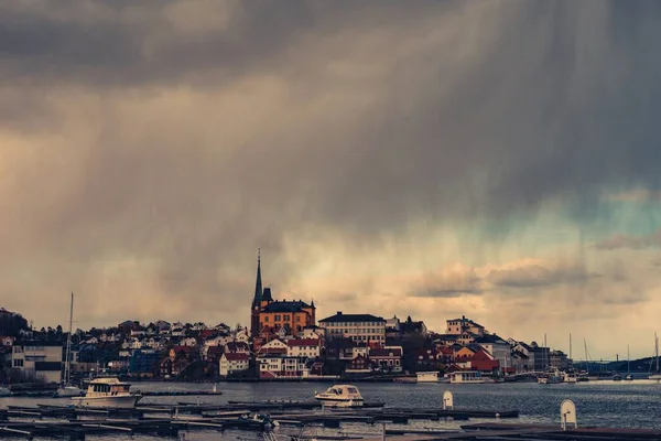 Beautiful shot of the city from Arendal, Norway with the clouds smearing down and raining — Stock Photo, Image